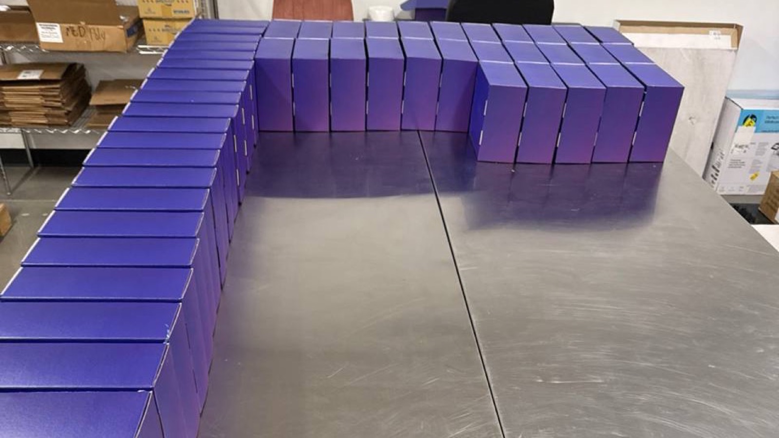 Kitted purple product boxes lined up on the assembly table at Uptime